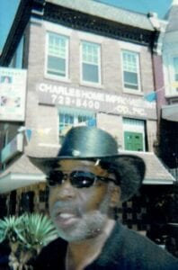 A man wearing sunglasses and a cowboy hat.